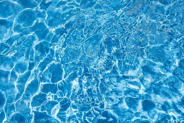 Wavy blue water surface with reflections