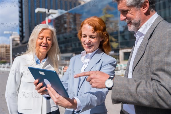 Group executives or businessmen and businesswoman in a business area. looking at the tablet