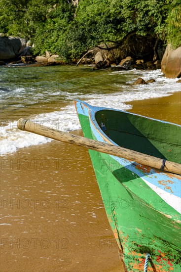 Rowing fishing boat on the shore of the unspoiled beach of Ilha Grande