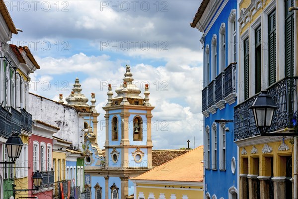 Colorful facades of old houses and historic church in Pelourinho neighborhood in Salvador city