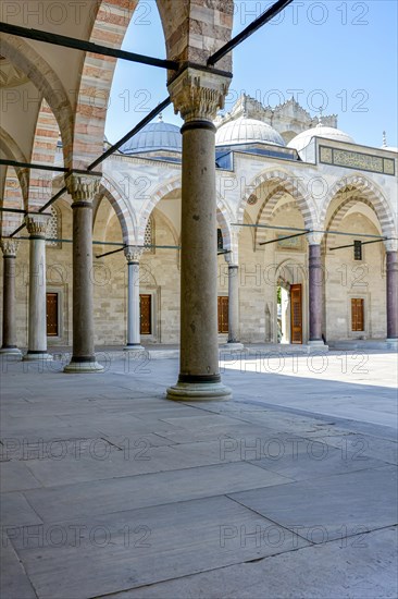 Inner courtyard and corridors with its arches and frescoes in the blue mosque in Itambul