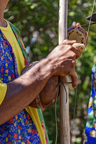 Berimbau player playing his instrument during typical folk festival in the interior of Brazil