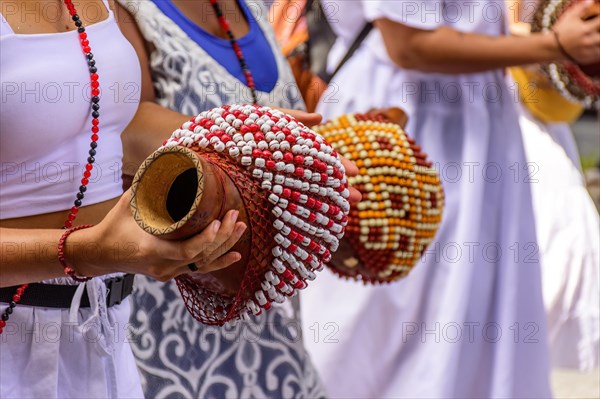 Woman playing a type of rattle called xereque of African origin used in the streets of Brazil during samba performances at traditional carnival festivities