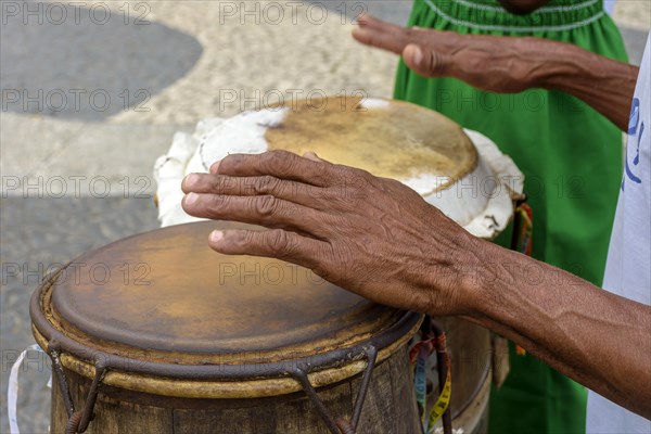 Percussionist playing a rudimentary atabaque during afro-brazilian cultural manifestation at Pelourinho on Salvador city