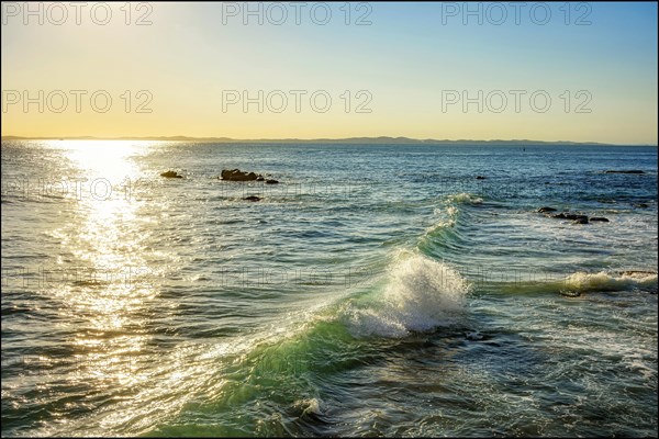 Sunset over the waters of the sea in the city of Salvador in Bahia with small waves breaking along the rocks