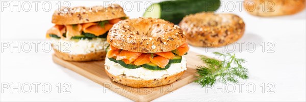 Bagel sandwich for breakfast topped with salmon fish on a board Panorama in Stuttgart