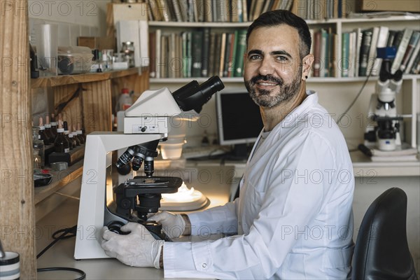 Scientist in front of microscope