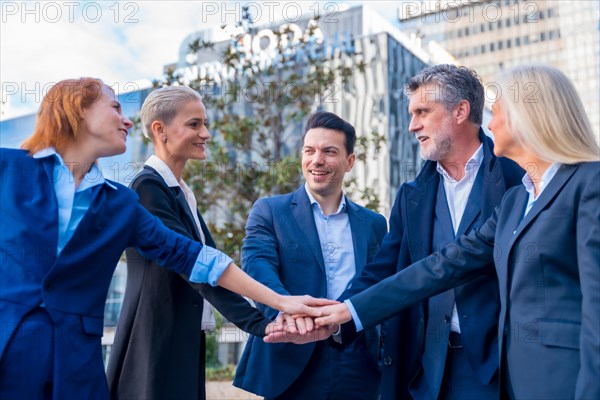 Successful Senior Executives High-Five in Celebration of Teamwork and Achievement