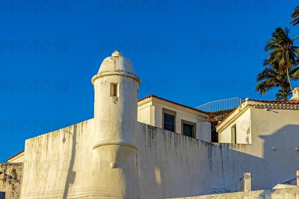 Walls and guardhouse of an old colonial fortification in the city of Salvador in Bahia illuminated by the sunset