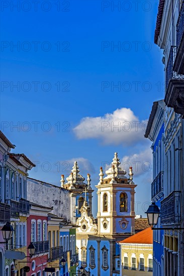 Colorful houses facades and historic church towers in baroque and colonial style with blue sky in the famous Pelourinho district of Salvador