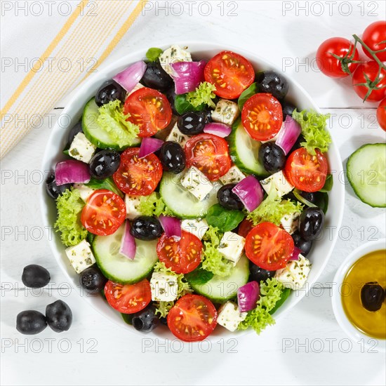 Greek salad with fresh tomatoes olives and feta cheese healthy nutrition food from above on wooden board square in Stuttgart
