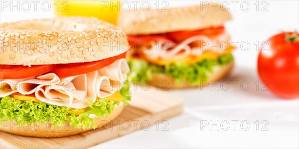 Bagel sandwich for breakfast topped with chicken ham close up panorama in Stuttgart