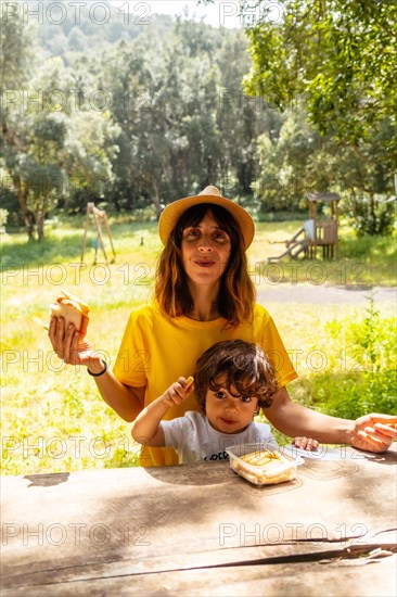 A mother eating in a children's playground in La Llania park in El Hierro