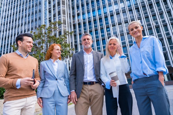 Group of coworkers walking going to work outdoors in a corporate office area