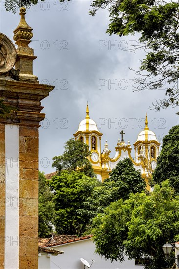 Church tower and old buildings among the vegetation of the historic city of Tiradentes in the state of Minas Gerais