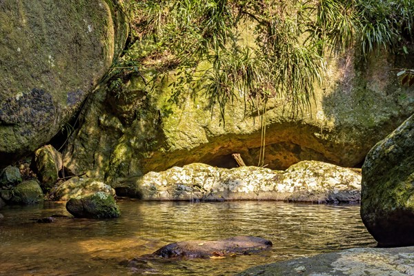 River running through the rocks and rainforest on Ilhabela island in Sao Sebastiao on the north coast of Sao Paulo state