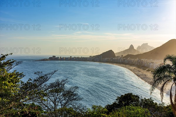 Copacabana beach and Rio de Janeiro mountains seen from above during summer sunset