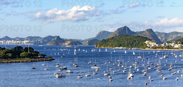 Panoramic image of Guanabara Bay with its boats and surrounded by the city of Rio de Janeiro with its hills during the afternoon