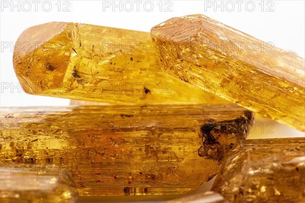 Studio photography of Brazilian imperial topaz in raw state with white background