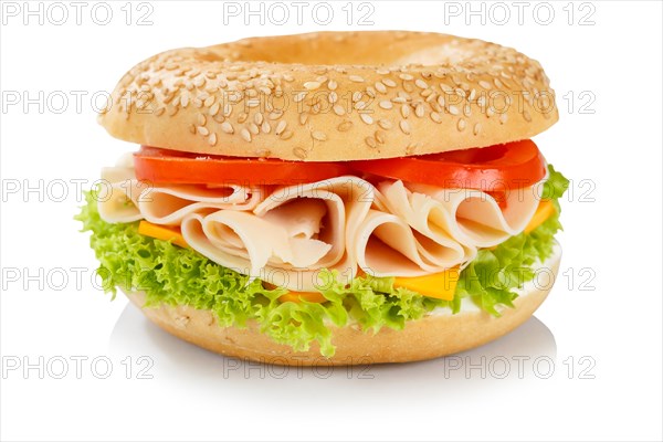 Bagel sandwich for breakfast topped with chicken and ham in front of a white background in Stuttgart