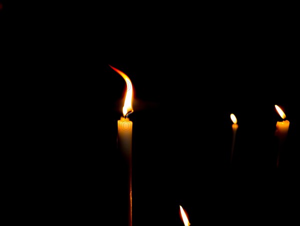 Lit candles in the dark