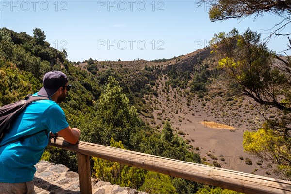 A young man at the Fireba volcano viewpoint of La Llania park in El Hierro