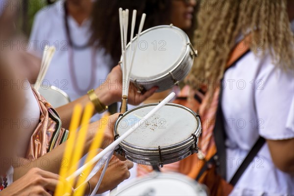 Tambourine player in crowded brazilian streets during traditional carnival festivities