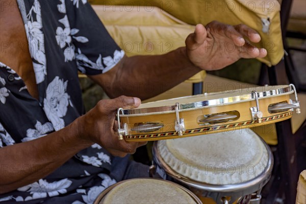 Musician playing tambourine in the streets of Pelourinho in Salvador in Bahia during a samba performance at Carnival