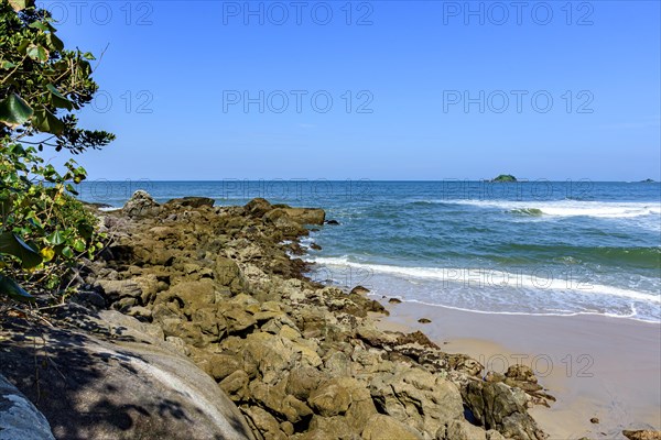 Stones advancing into the sea on a paradise beach in Bertioga on the coast of the state of Sao Paulo
