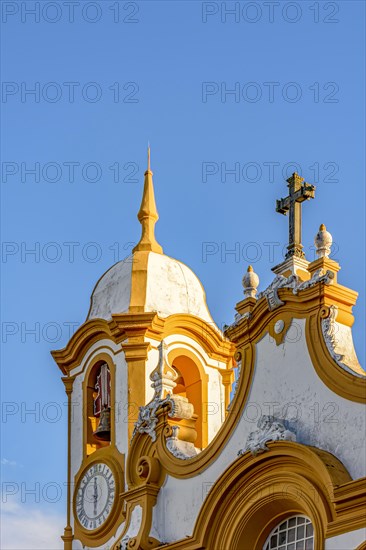 Historic church tower with bell and clock in the famous city of Tiradentes in Minas Gerais