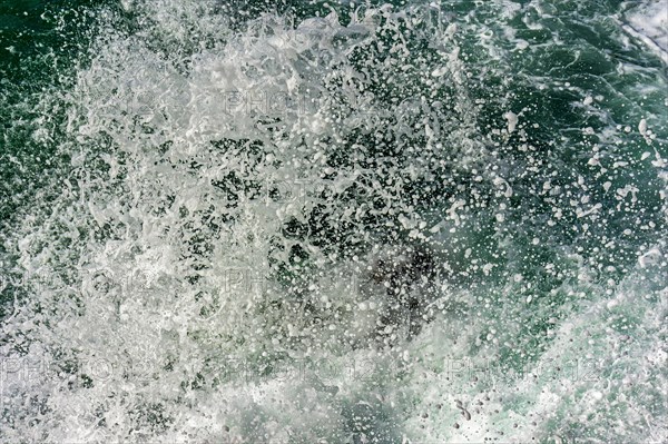 Texture of drops of sea water splashing into the air when waves crash against rocks
