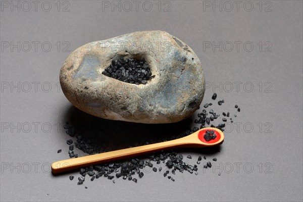 Black Hawaiian salt on spoons and in hollowed stone