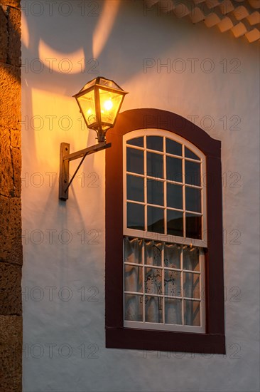 Old metal street lamp on the facade of a colonial-style house in the historic city of Tiradentes