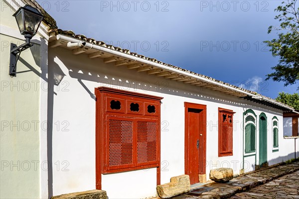 Street with ancient colonial style houses with colorful doors and windows in the historic city of Tiradentes in Minas Gerais