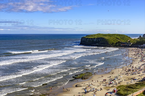 Beach on a beautiful sunny day in the summer of Torres city on the coast of Rio Grande do Sul state