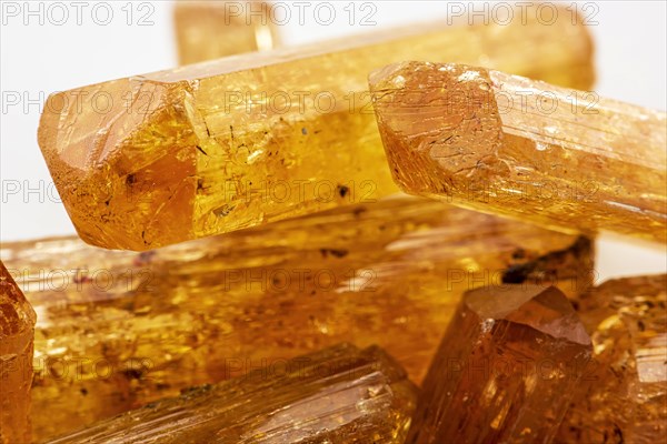 Studio photography of Brazilian imperial topaz in raw state with white background