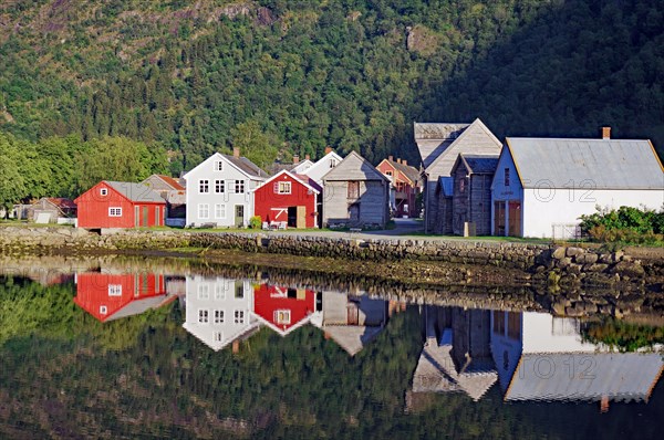 Wooden houses reflected in calm waters