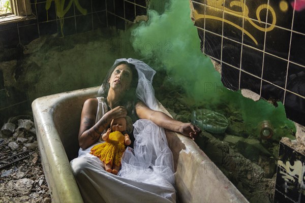 Deranged bride with a doll in a bathtub. Inspired by the traditional American legend of la llorona