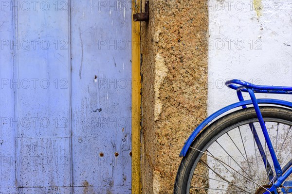 Detail of old bicycle stops in front of the historic house in the city of Paraty