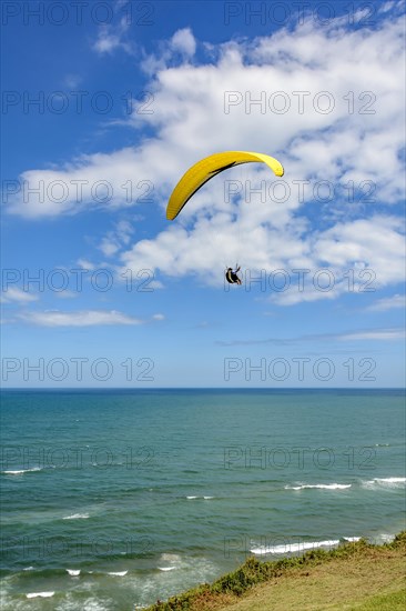 Paragliding flight over the sea from the city of Torres on the coast of the state of Rio Grande do Sul