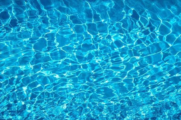 Wavy blue water surface with reflections