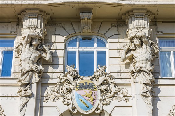 Stone figures as support on a historic facade