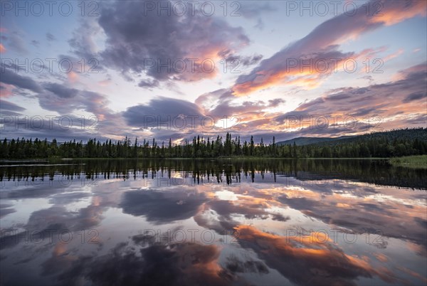 Dramatic sunset by the river Namsen with reflection