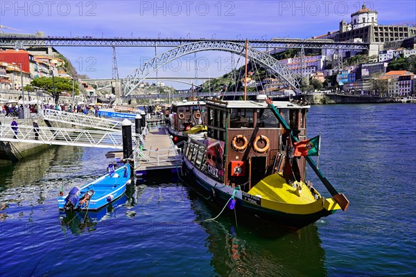 View of the Dom Luis I bridge over Douro River and terracota rooftops