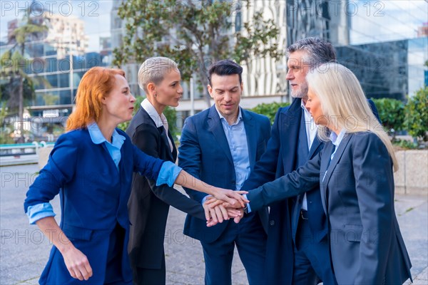 Senior Executives Unite with High-Five Gesture in Team Building and Collaboration
