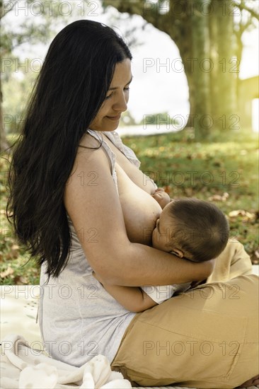Mom and baby. It celebrates the act of breastfeeding as a nurturing and intimate moment between the two