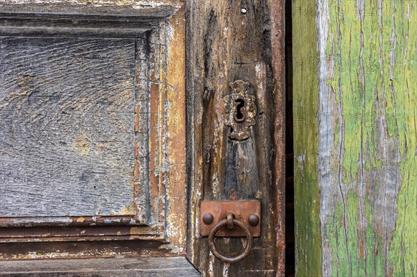 Detail of ancient wooden door and lock deteriorated by time and rust in a colonial style house in the historic city of Diamantina in Minas Gerais