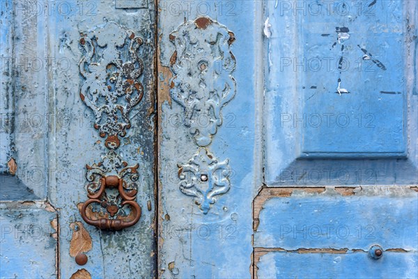 Detail of old wooden blue door and lock deteriorated by time and rust in a colonial style house in the historic city of Diamantina in Minas Gerais
