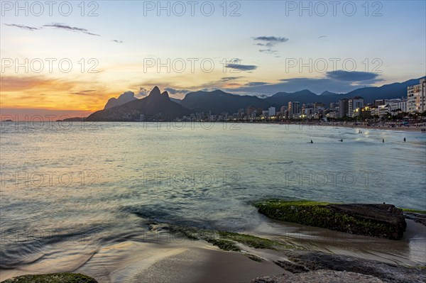 Beautiful sunset behind the mountains of the city of Rio de Janeiro on Ipanema beach