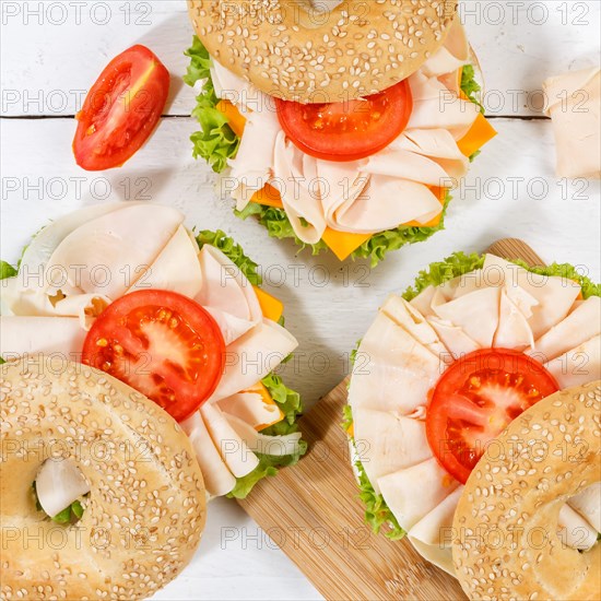 Bagel sandwich for breakfast topped with chicken ham from above square in Stuttgart